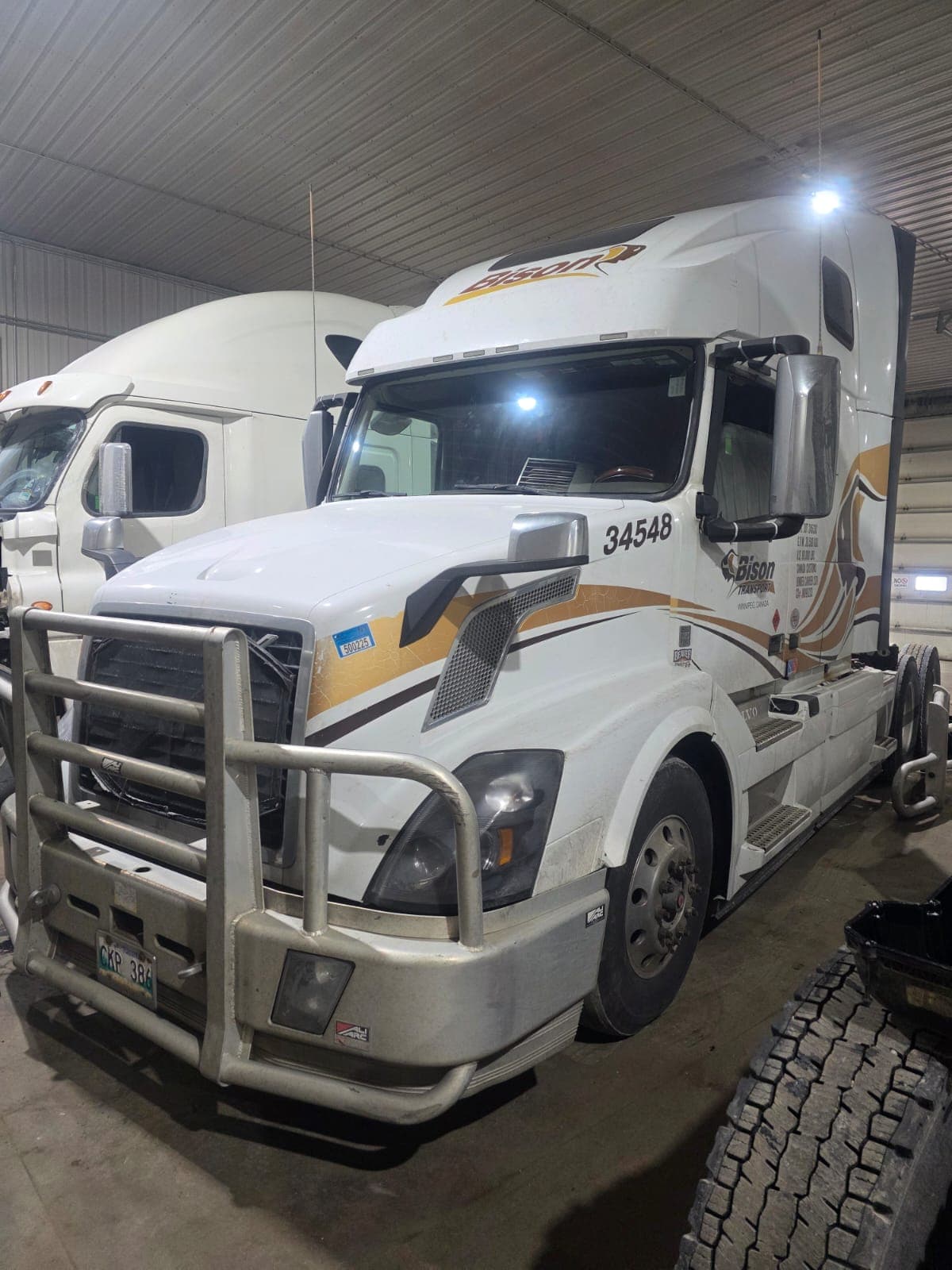 Technician repairing a semi-truck engine in Winnipeg